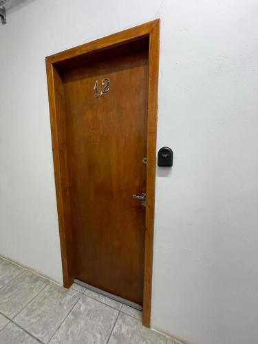 a wooden door with the number on it at Villa Bilac - Amplos Studios 2km da Vila Germânica in Blumenau