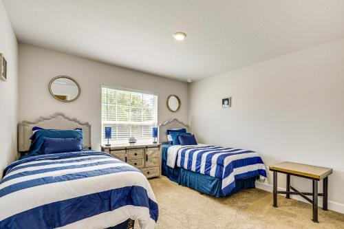 a bedroom with two beds and a window at Screened Lanai Relaxing Retreat in Ocala! in Ocala