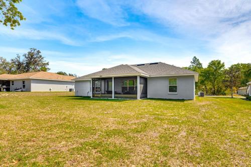 a white house with a large yard at Screened Lanai Relaxing Retreat in Ocala! in Ocala