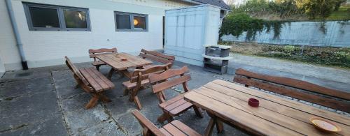 a group of wooden tables and benches in front of a building at Magisches Wachstein in Wachstein