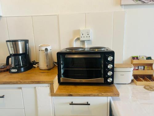 a microwave sitting on a counter in a kitchen at SapphireA@54 in Windhoek