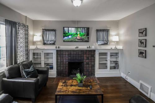 a living room with a couch and a fireplace at Chic Denver Family Retreat Free Parking & Prime Location in Denver