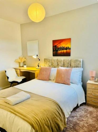 a bedroom with a bed with a desk and a chair at Room 3 Shared House in L6 in Liverpool