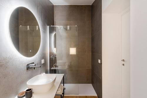 a bathroom with a sink and a mirror at Sole Luxury terrace,Central apartment in Matera