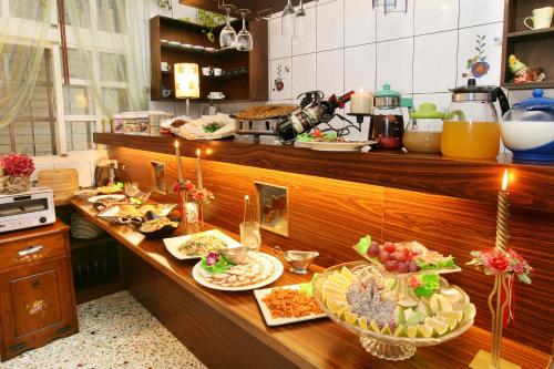 a kitchen with many plates of food on a counter at Sweetheart Homestay in Luodong