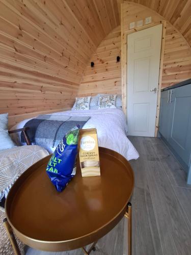 a room with a bed and a table in a cabin at Beautiful and Cosy Garden Pod Saintives in Carbis Bay