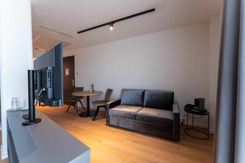 a living room with a couch and a table at Frames Hotel GmbH in Mülheim-Kärlich