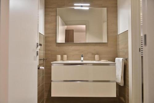 a bathroom with a sink and a mirror at Karol Wojtyla Airport Bari in Bari