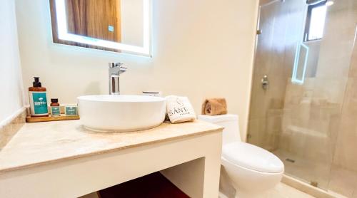 a bathroom with a sink and a toilet at Santal Tulum Condo Hotel By Marea in Tulum