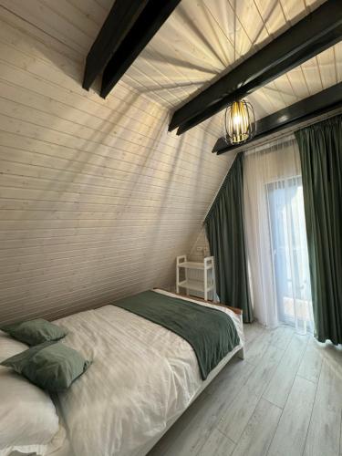 a bedroom with a bed and a large window at LKS A-frame in Corbi
