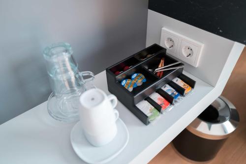 a table with a blender and a box on it at Frames Hotel GmbH in Mülheim-Kärlich
