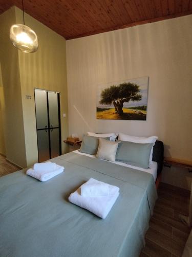 a bedroom with two beds with towels on them at Olive apartment in Paianía
