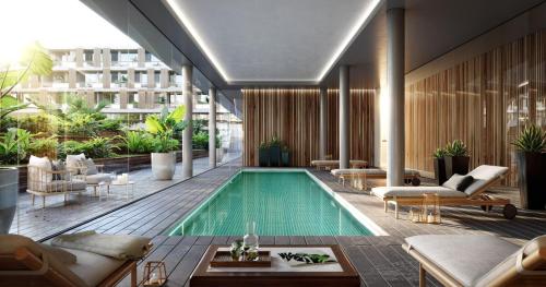 a pool in the middle of a building at Complejo Prana, pileta, parilla, cine y gimnasio in San Isidro