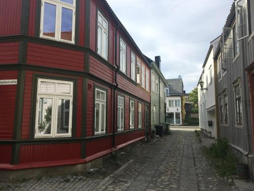 an empty street with a red and white building at Stor attraktiv studioleilighet i sentrum in Trondheim