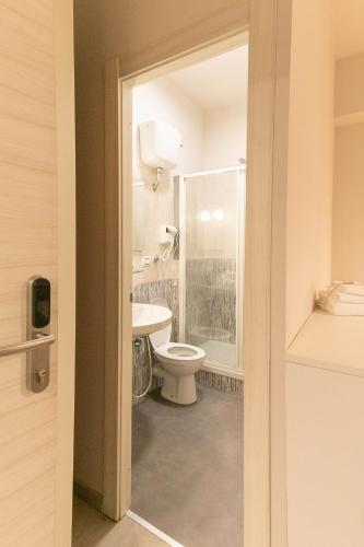 a bathroom with a toilet and a sink at Dafne Room Suites con terrazza in Rome