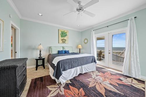 a bedroom with a bed and a view of the ocean at Sea-Side in Dauphin Island
