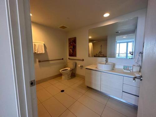 ハランデール・ビーチにあるCozy 1BR Retreat wPool BeachService & Full Kitchenの洗面台、トイレ、鏡のあるバスルーム