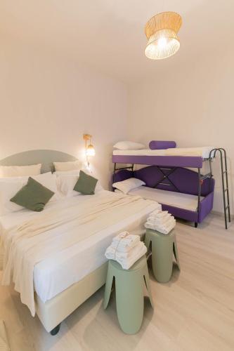 a bedroom with two beds and a table and a lamp at Dafne Room Suites con terrazza in Rome