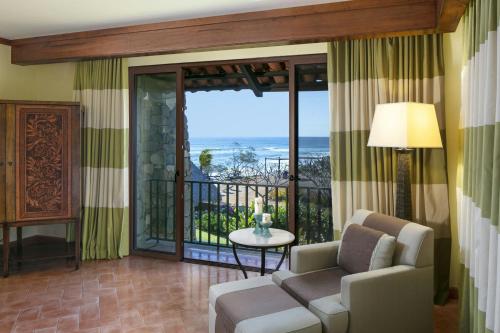 a living room with a couch and a view of the ocean at JW Marriott Guanacaste Resort & Spa in Tamarindo