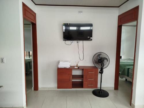 a room with a flat screen tv on a wall at Cabañas MariaBonita in Villavicencio