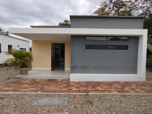 a modern house with a gray and white facade at Cabañas MariaBonita in Villavicencio