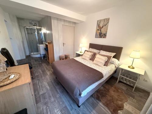a bedroom with a bed with pillows and a table at Douce Campagne in Le Pouzin