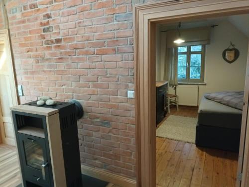 a brick wall in a room with a bedroom at landhaus rosmarin in Oschersleben