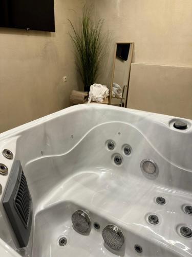 a large white bath tub in a bathroom at Panorama Luxury Suite in Palaios Panteleimon