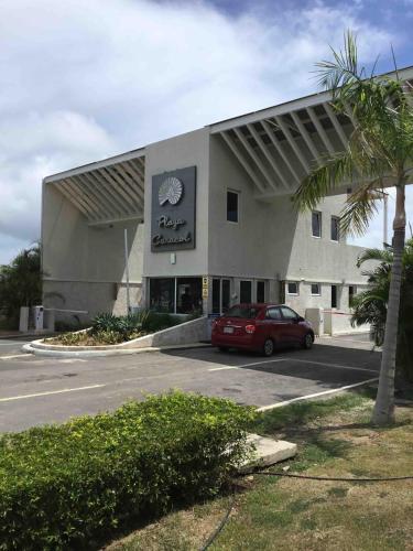 a car parked in a parking lot in front of a building at Great 1 bedroom apartment by the beach CHame, Playa Caracol in El Quindio