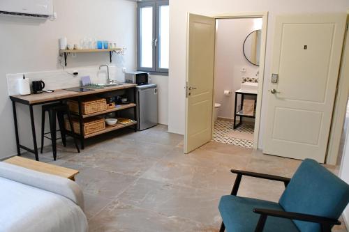 a room with a kitchen and a living room with a table at Aegina-town-old-center in Aegina Town