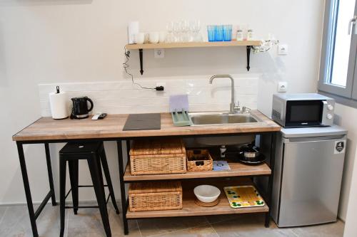 a kitchen with a sink and a counter with a counter at Aegina-town-old-center in Aegina Town