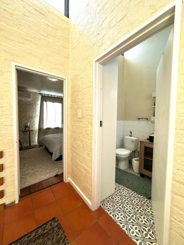 a bathroom with a bed and a toilet in a room at Comfy full apartment in Stellenbosch