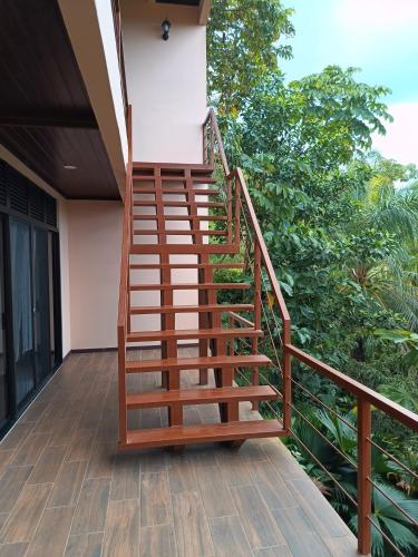 a wooden staircase on the side of a house at Corcovado Accommodations-pool-best views-nature in Puerto Jiménez
