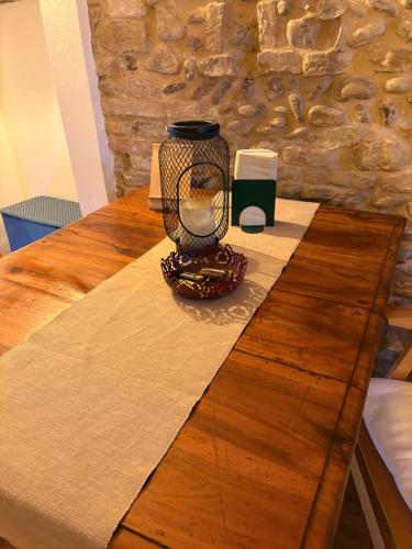 a candle on top of a wooden table at Terra Cielo alloggio di Porta Santi in Cesena