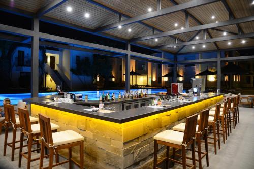a bar in a restaurant with chairs around it at Samara Hotel Bodrum Ultra All Inclusive in Torba