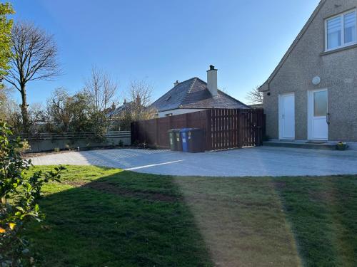 a driveway in front of a house with a fence at 10 Berisay Place in Stornoway