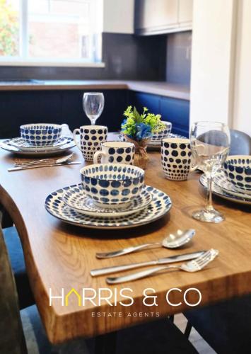 a wooden table with blue and white dishes on it at The Poulton Paradise in Poulton le Fylde
