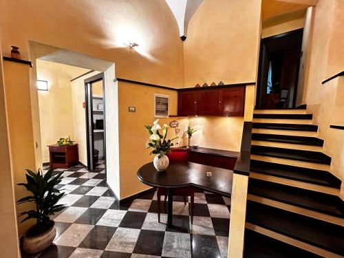 a living room with a table and a staircase at La Poesia Apartment in Monterosso al Mare