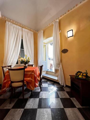 a dining room with a table and a window at La Poesia Apartment in Monterosso al Mare