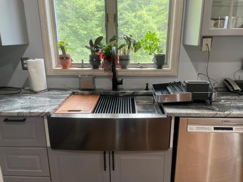 a kitchen counter with a sink and a window at Where Memories Are Made in West Kill