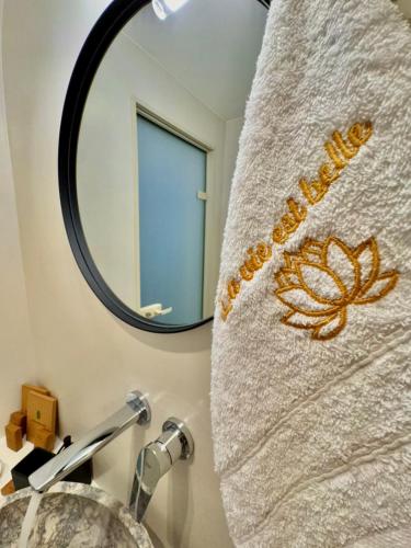 a bathroom with a towel hanging over a sink at La vie est belle Luxury Residence With Jacuzzi 1 in Pounda