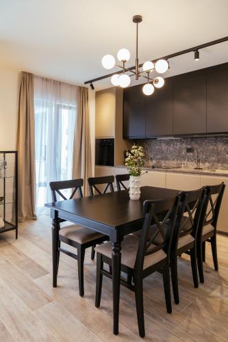 a dining room with a black table and chairs at Apartments Toni in Split