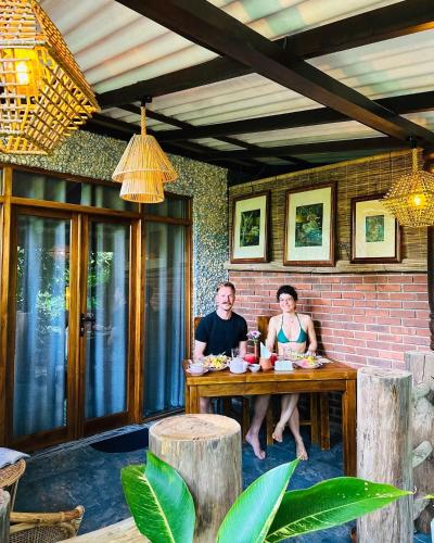a man and a woman sitting at a table at La Casa Bella in Ella