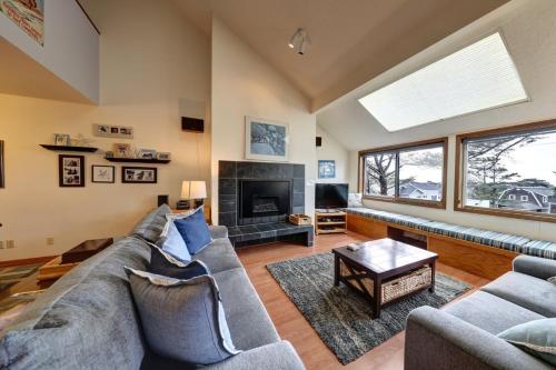 a living room with a couch and a fireplace at Cannon Beach Condo Ocean Views ! Close to Beach! in Cannon Beach