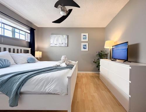 a bedroom with a bed and a tv on a dresser at Sea View Escape Unit #2 in San Clemente