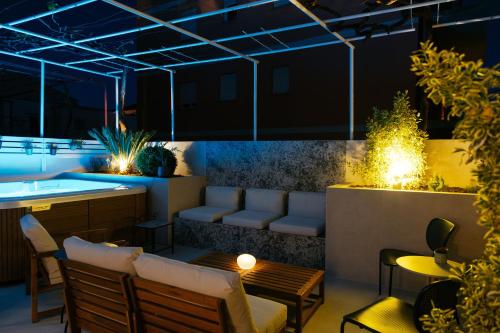 a restaurant with a bar with chairs and tables at Apartments Toni in Split