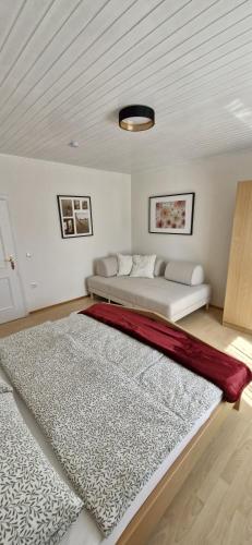 a white room with a bed and a rug at Ferienwohnung Karin in Sankt Jakob im Rosental