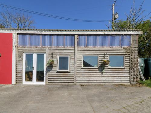 a building with a lot of windows and a garage at The Farmhouse in Ciliau-Aeron