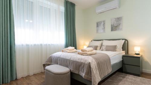 a bedroom with a bed with towels on it at LIMIDI HOMES --- Spacious Two-Bedroom Apartment in City Centre --- Ideal Location for Exploring Veliko Tarnovo in Veliko Tŭrnovo