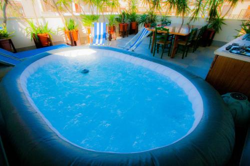a large swimming pool in a room with a table at Old Style by the sea, roof terrace with pool and kitchen, Ladispoli in Ladispoli
